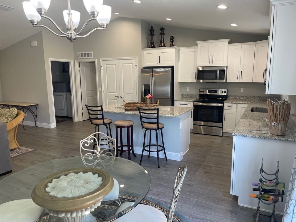 OPEN LIVING ROOM, DINING ROOM, AND KITCHEN WITH BIG BEAUTIFUL ISLAND.