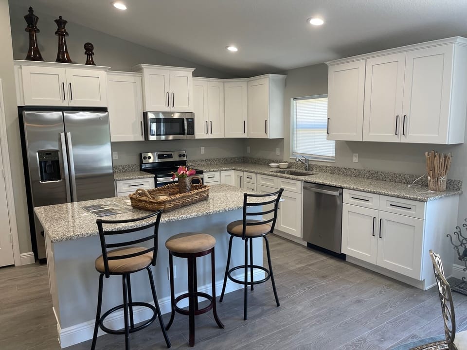 OPEN LIVING ROOM, DINING ROOM, AND KITCHEN WITH BIG BEAUTIFUL ISLAND.