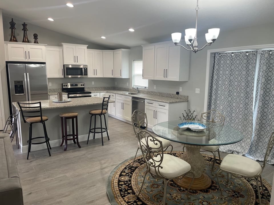 OPEN LIVING ROOM, DINING ROOM, AND KITCHEN WITH BIG BEAUTIFUL ISLAND.