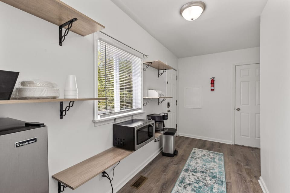 Discover the convenience of our kitchenette, equipped with a Keurig and drip coffee maker combo for your morning brew, a mini fridge with a freezer to store your essentials, toaster and a microwave for quick and easy meals.