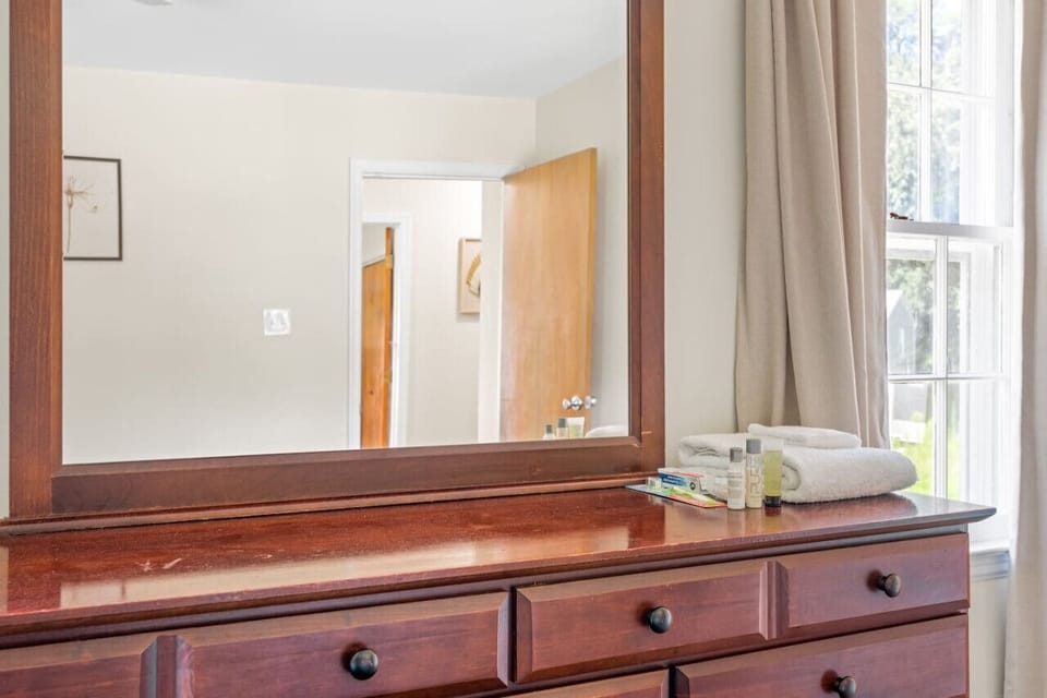 Experience tranquility in our front-side bedroom, boasting a Queen-size bed for restful nights, a TV for entertainment, a soothing ceiling fan for added comfort, and a convenient work desk for your productivity needs.