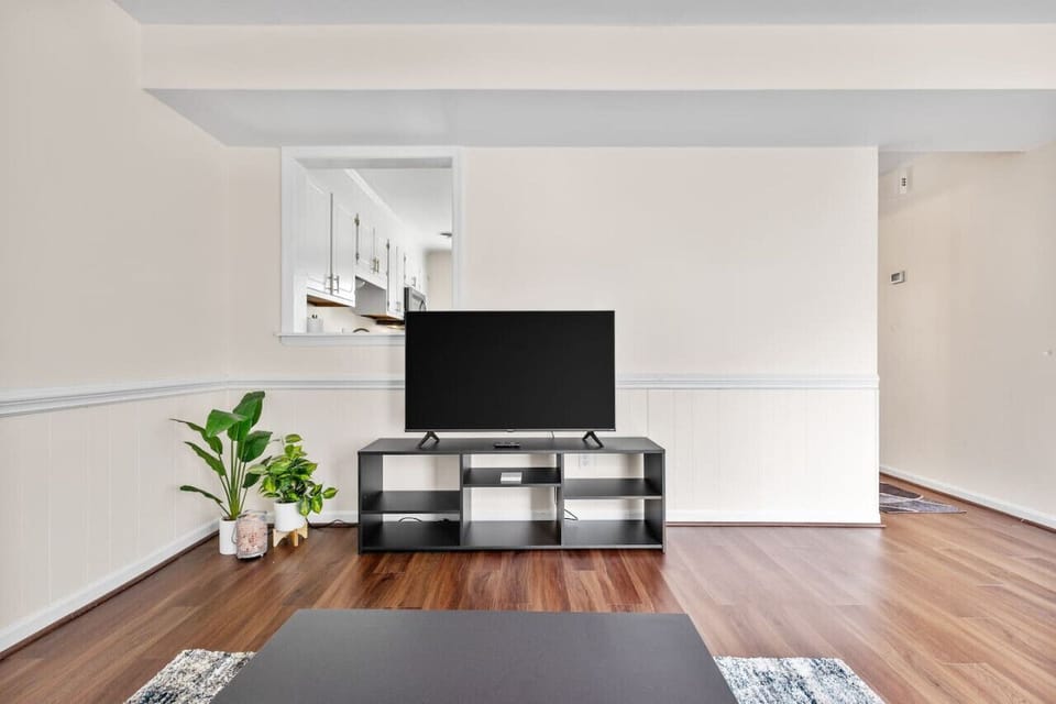 Relax in the plush living room with a flat-screen Roku Smart TV and easy access to the back patio through a sliding glass door.