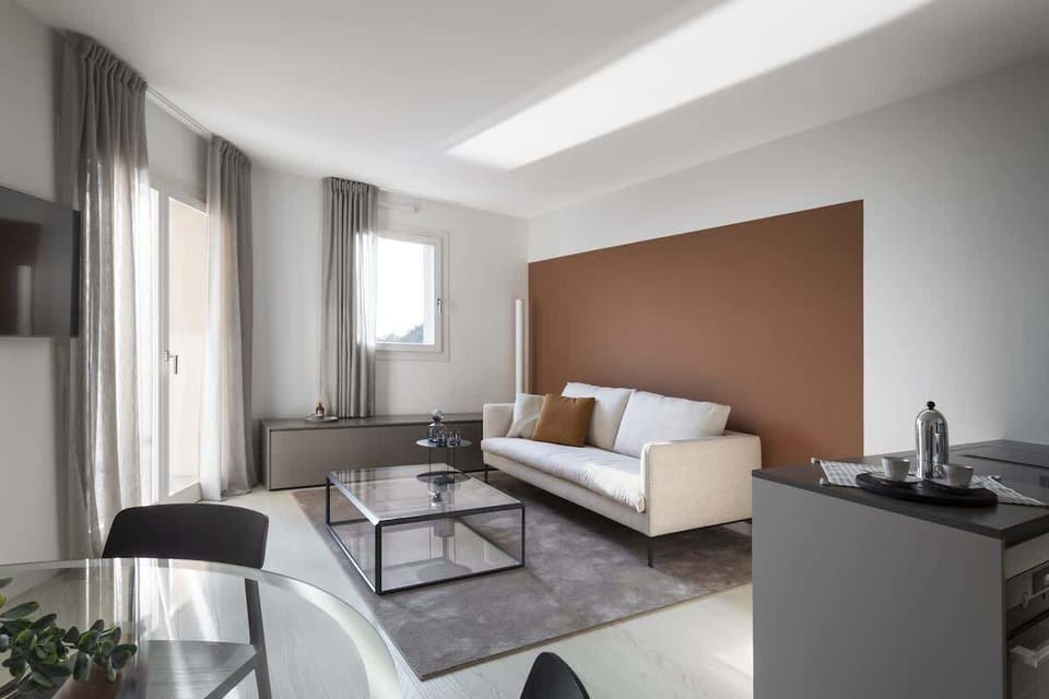 Luxurious living room at Portopiccolo Apartments - Pearl in the Village. Ideal for couples, families, and business trips. A luxury apartment, fully equipped and furnished with every comfort. Characterized by a breathtaking sea view. Featuring two bed