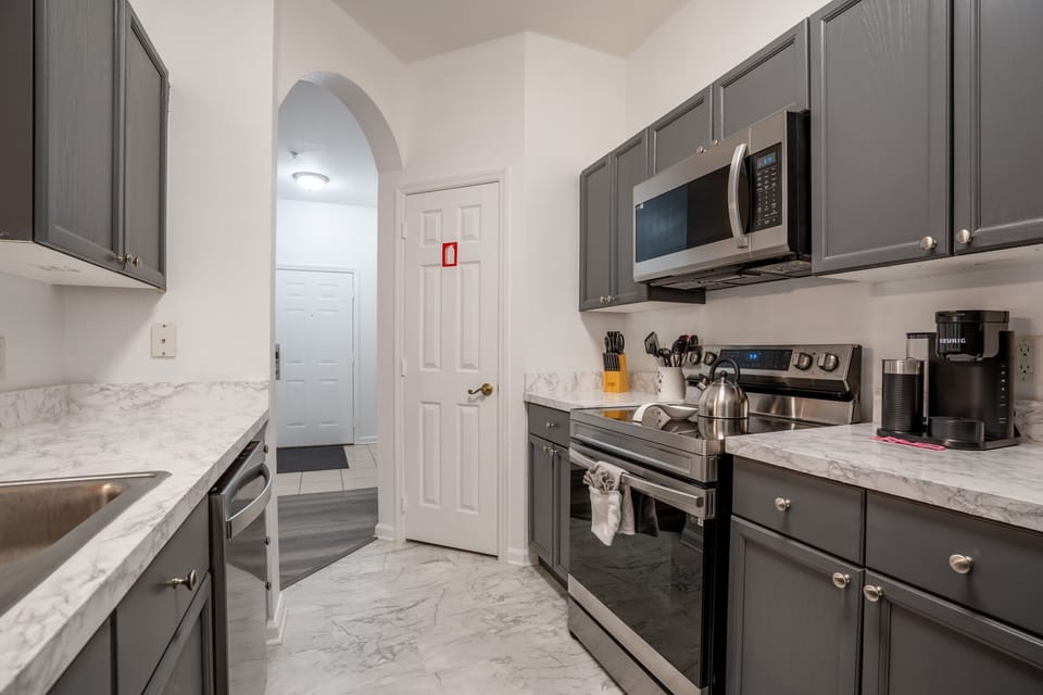 Modern kitchen with stainless steel appliances and marble countertops