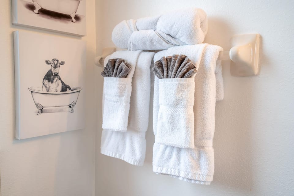 Freshly folded towels neatly arranged on a wall rack in the bathroom