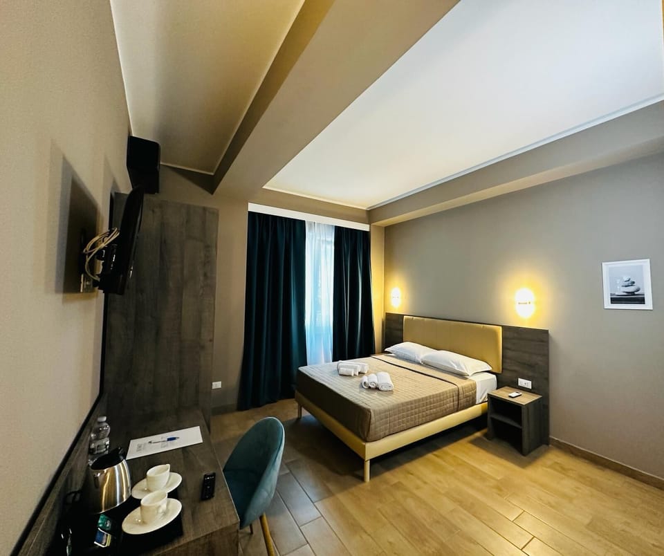 Deluxe Triple Room | Minibar, in-room safe, desk, blackout drapes