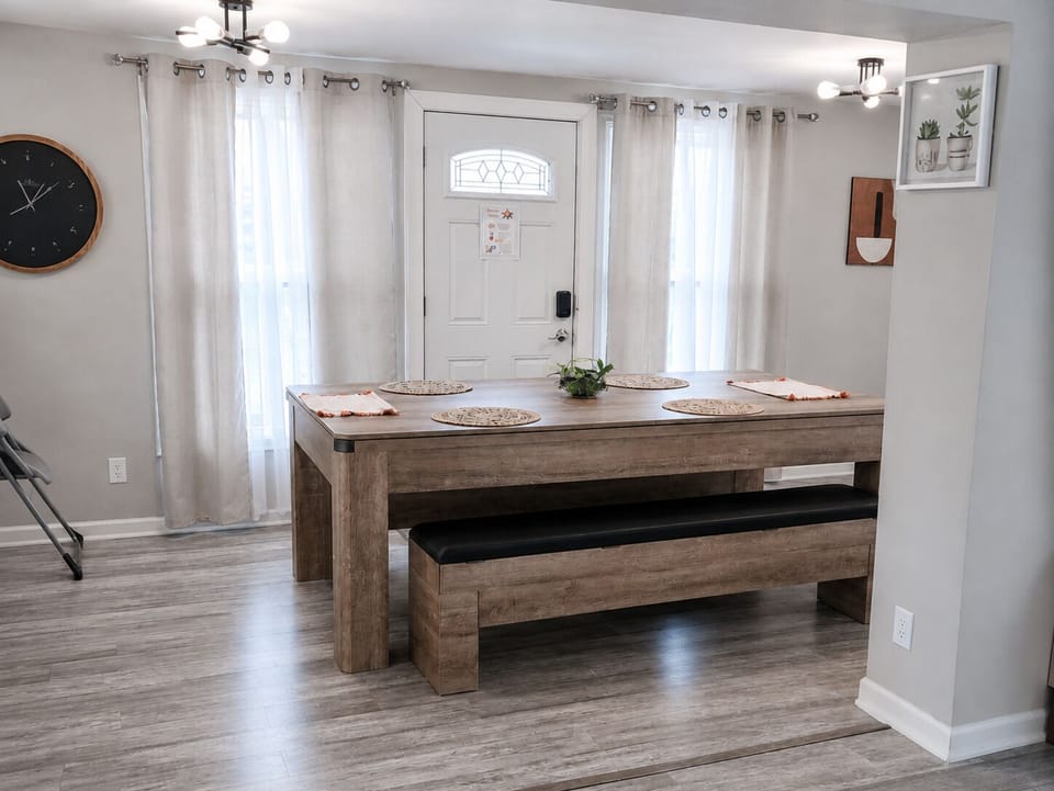 Spacious dining table seats 8 and opens directly to the fenced backyard