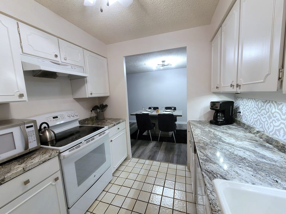 Kitchen, fully stocked with full size fridge, oven, microwave and stovetop