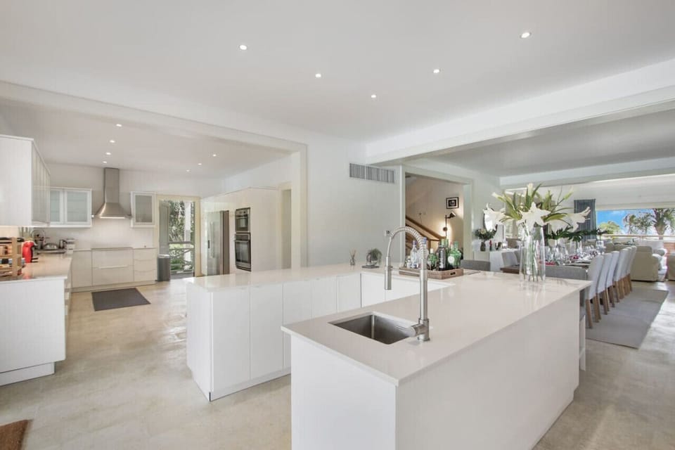 Caleton Estates 52: open floor plan with bar - kitchen - dining area