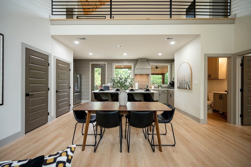 Modern open-concept kitchen and dining area with stylish decor and warm tones!