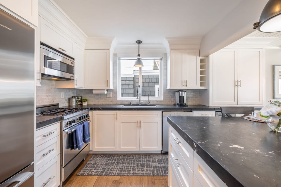 Kitchen is fully equipped and features modern stainless steel appliances.