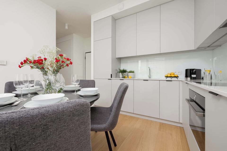 Bright kitchen with dining table and fresh flowers