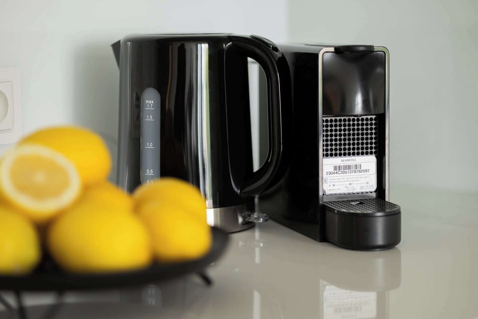 Stylish kitchen countertop with coffee machine and lemons