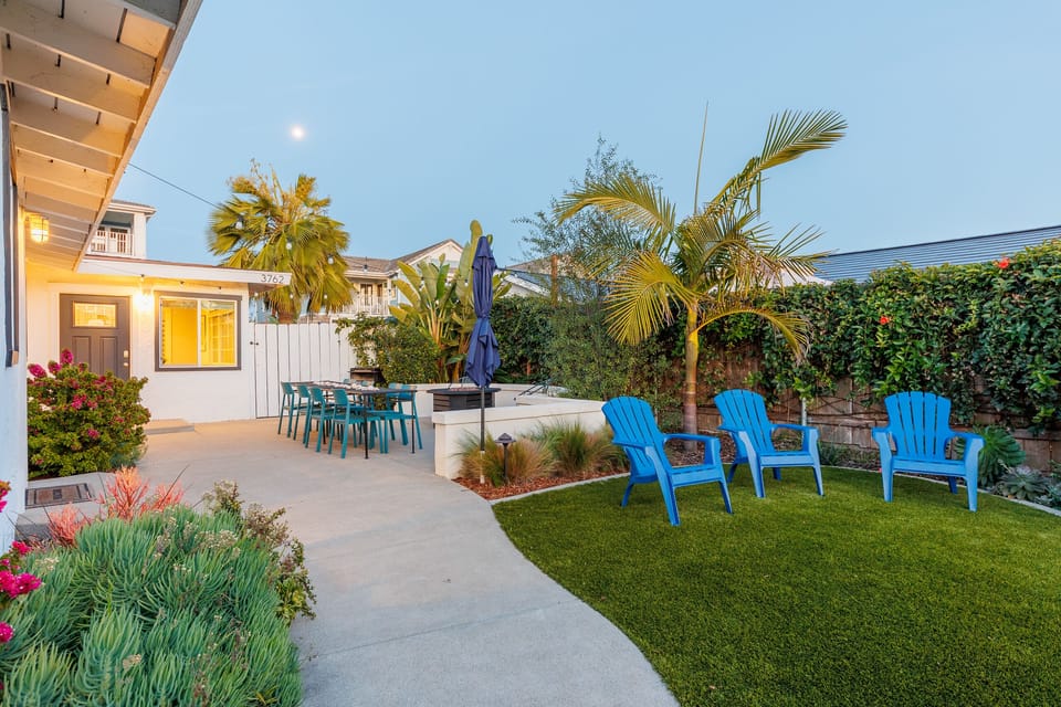 Front patio with outdoor dining table, Adirondack chairs, palm t