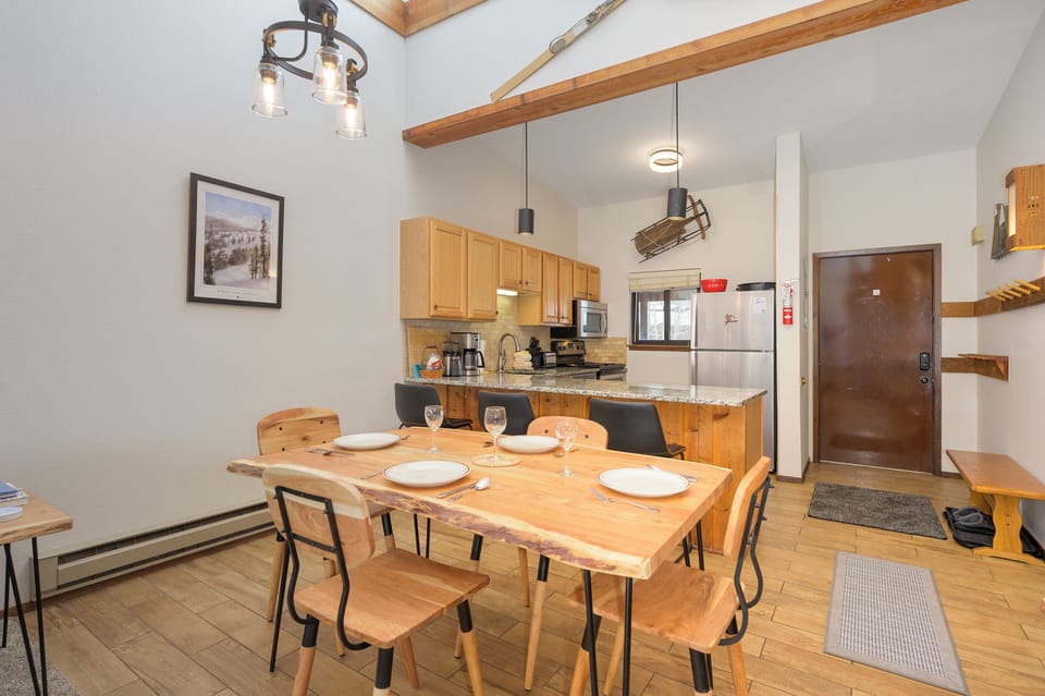Your mountain retreat features rustic wood beams, fully equipped kitchen, and cozy dining table where you'll share memorable meals.