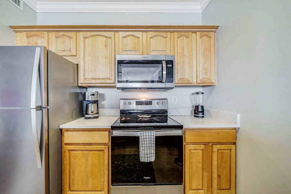 The fully equipped kitchen features granite countertops, stainless-steel appliances, and everything you need to cook meals for family and friends.