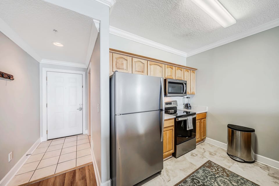 The fully equipped kitchen features granite countertops, stainless-steel appliances, and everything you need to cook meals for family and friends.