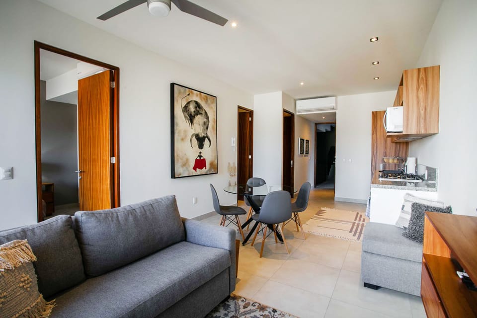 The well-conditioned living room boasts air-conditioning, ceiling fan and access to the private balcony