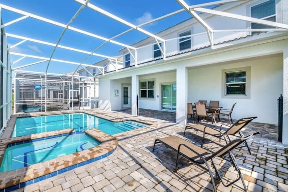 The lanai features a dining table and lounge chairs.