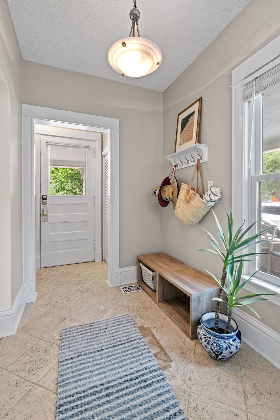 Step into your welcoming entrance where thoughtful touches like wall hooks and a cozy bench make arriving feel like coming home.