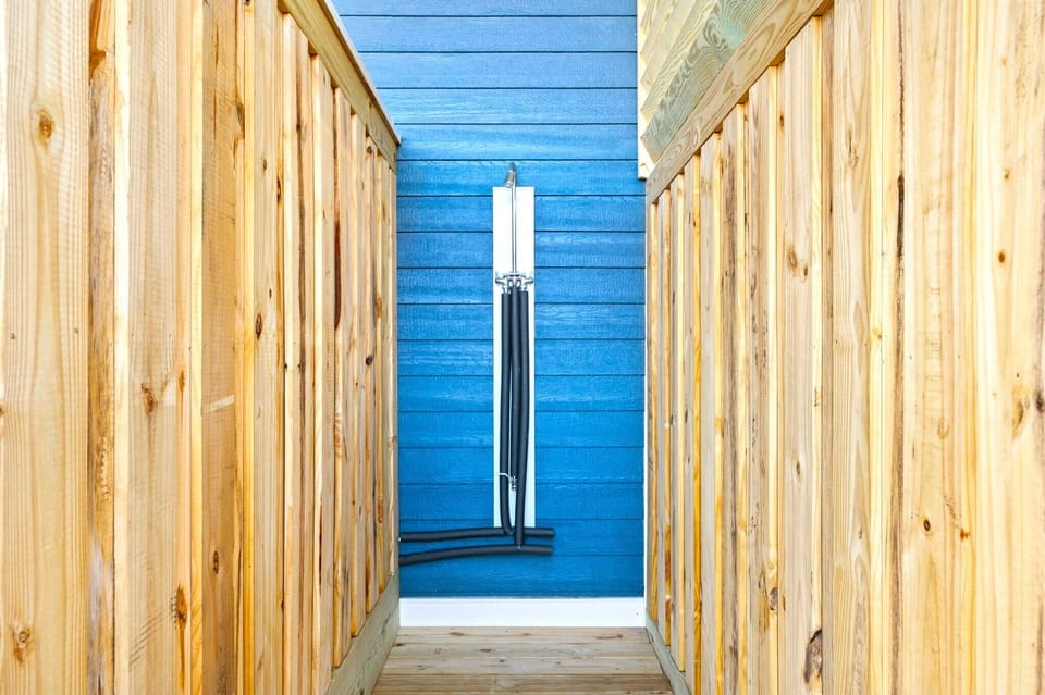 Private Outdoor shower conveniently located next to the pool for refreshing moments amidst the serene outdoor surroundings.