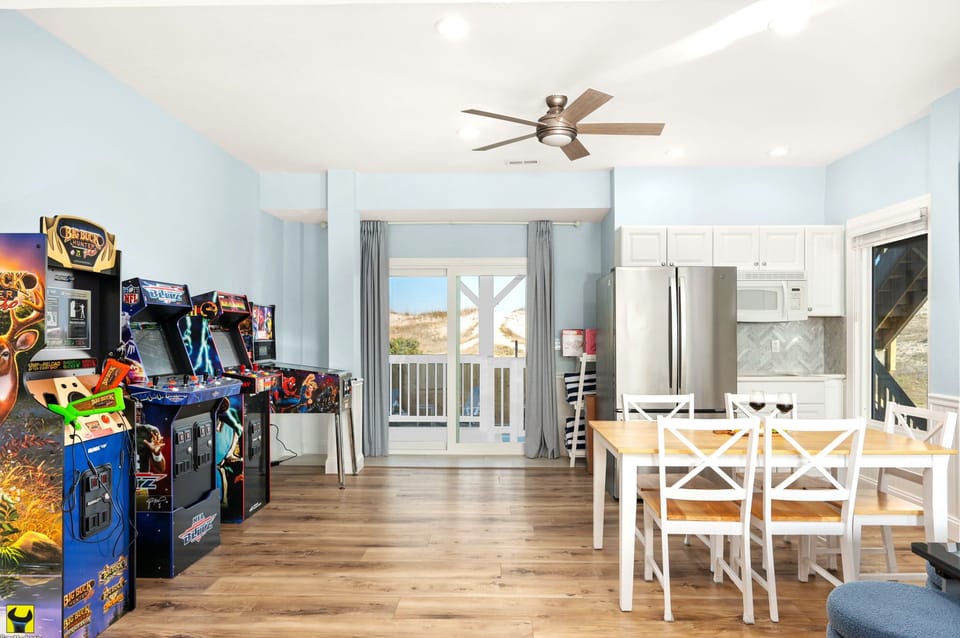 Equipped with a large TV, refrigerator, and a 6-seater table, this space is the ultimate hub for fun and relaxation. Plus, with sliding door direct access outside the house, you can easily tra