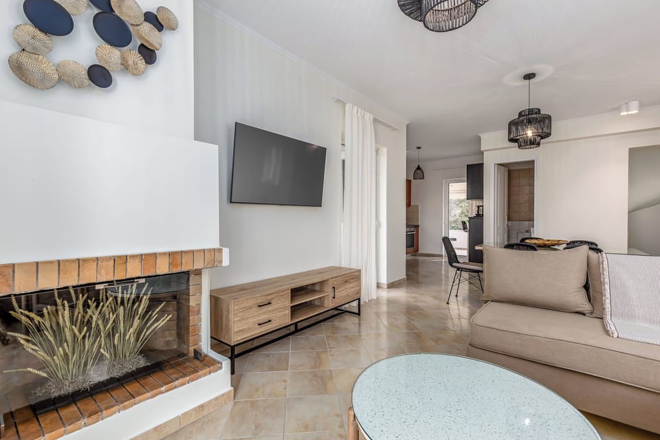 "Relax in style in our spacious living room, featuring a sleek modern design, a cozy fireplace, and ample seating for all."