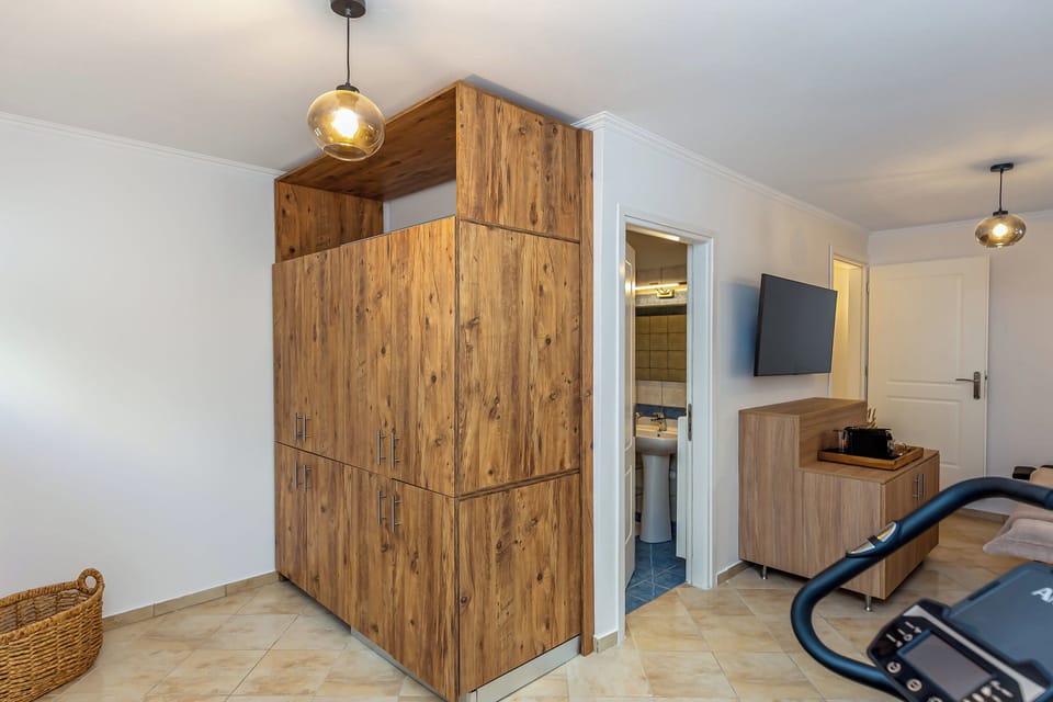 "Energize your stay with our well-equipped gym, featuring a static bicycle and yoga mat for your fitness needs."