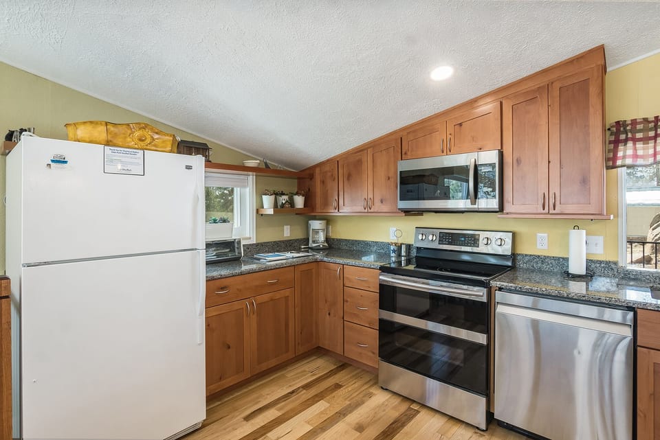 Kitchen with a full size refrigerator, oven, microwave and dishwasher