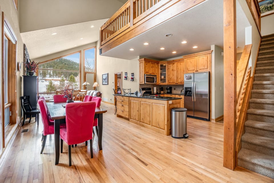 Kitchen opens into the dining area. 16 stairs to upper level