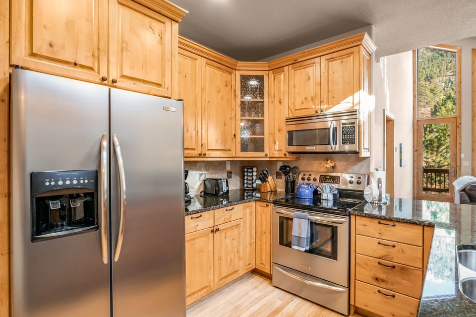 Well appointed kitchen with sleek, stainless steel appliances.