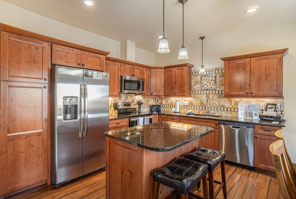 Island with 2 stools in this open kitchen