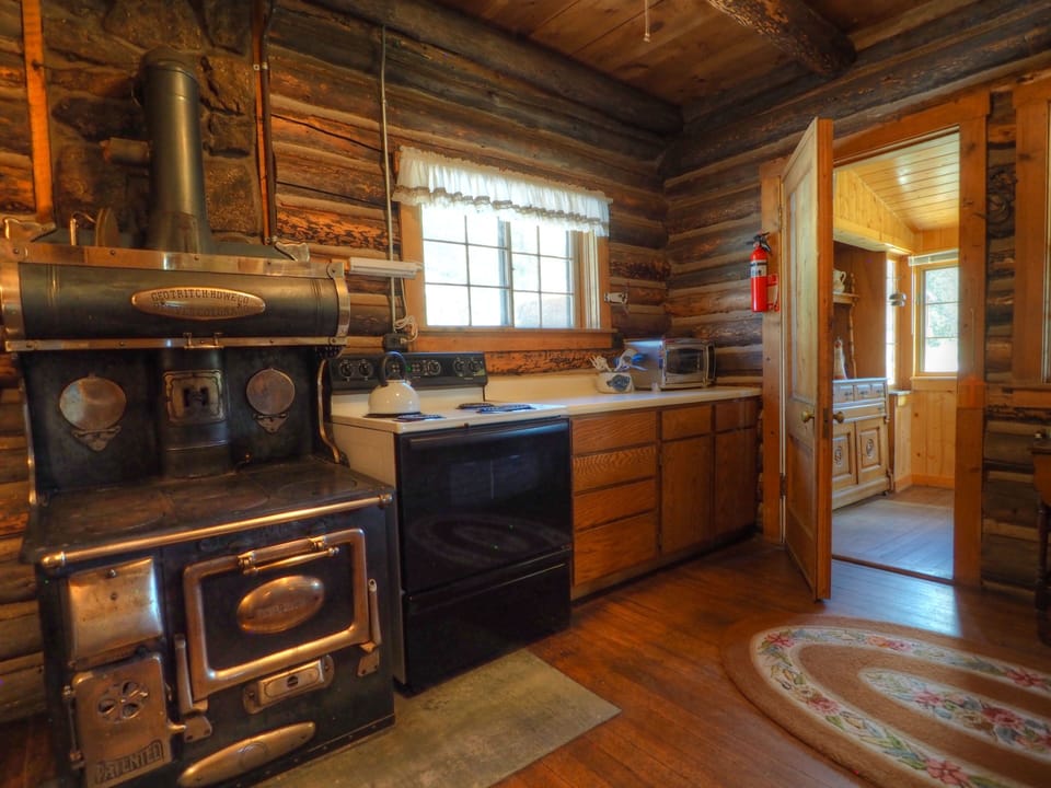The antique stove is not operational. The electric "modern" range will take care of your cooking needs.