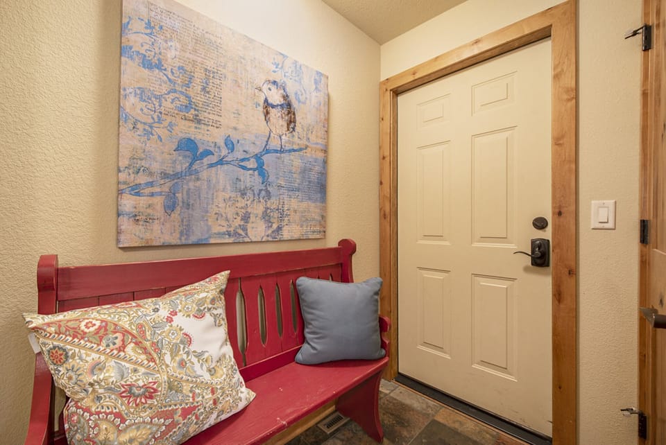 Fall River Retreat in Estes Park, Cute sitting area in the hallway. This door leads to the garage, not accessible to guests.
