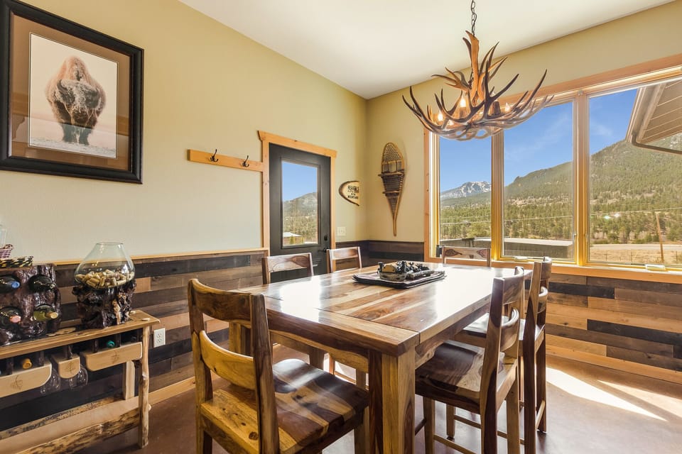 The large wooden dining table can comfortably seat six