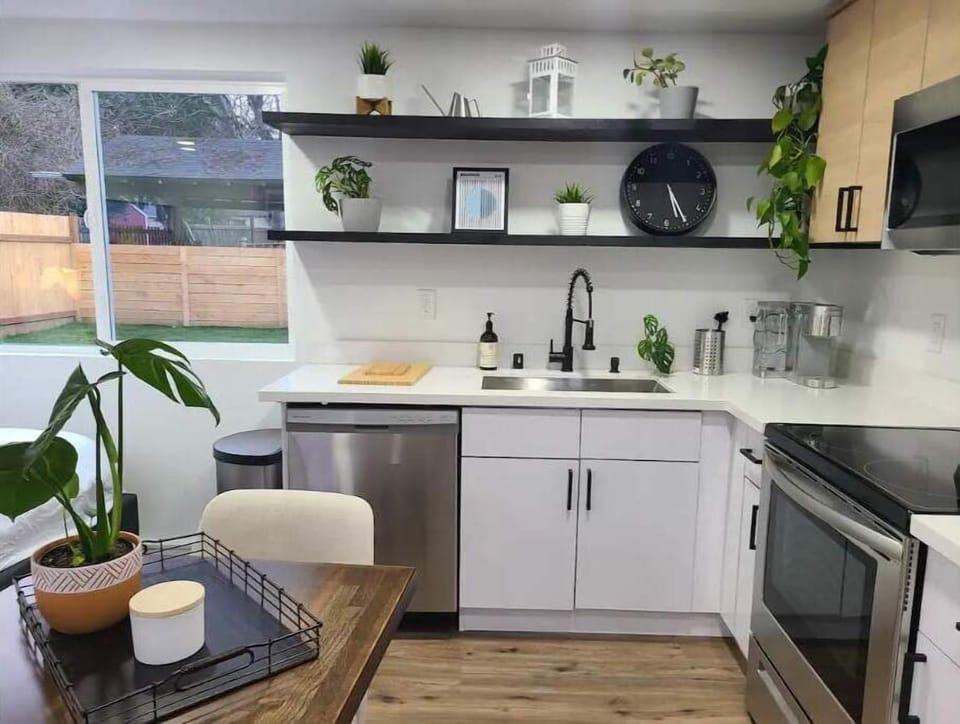full sized kitchen w/ dishwasher, oven, microwave, and large fridge