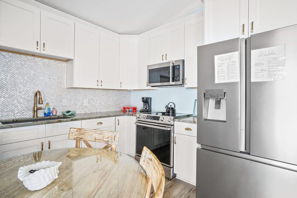 Bright, modern kitchen with stainless steel appliances and cozy dining nook