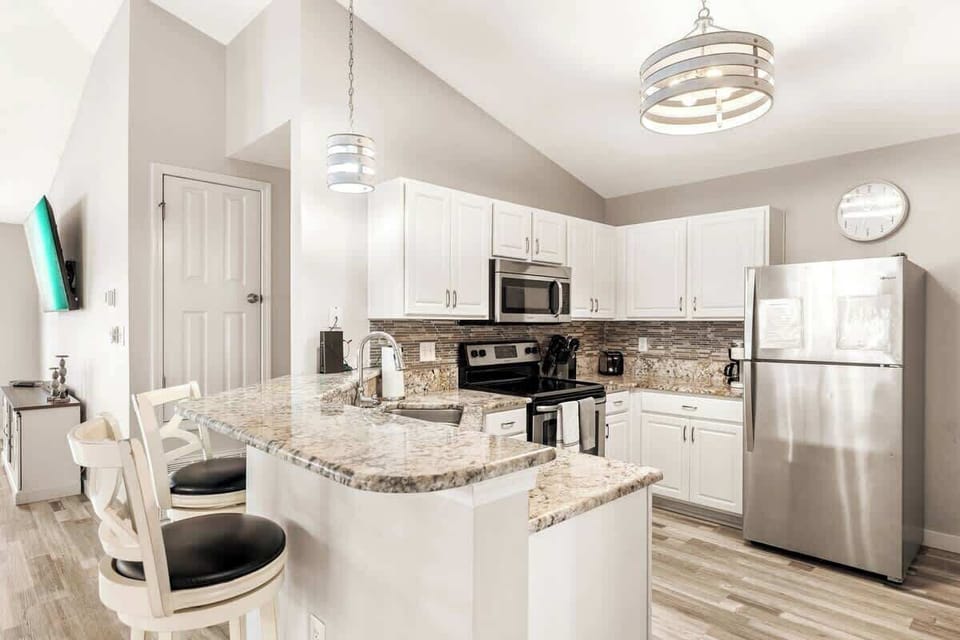 Gather at the breakfast bar for a quick bite with seating for 2.