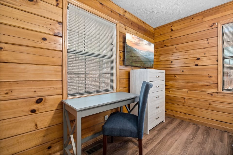 Desk and comfortable chair in the primary bedroom is perfect for working.