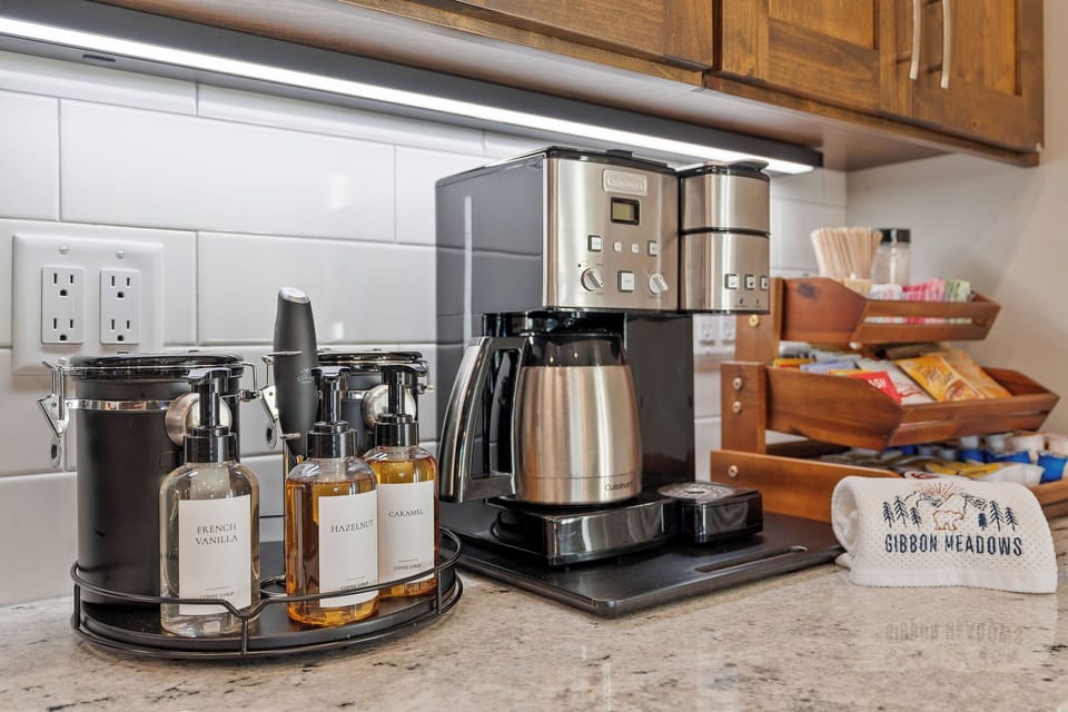 Indulge in our Cocoa, Tea, & Coffee Bar. Choose from medium/ dark roast coffee for single pot or cup. Elevate your drink with French Press, frother, coffee grinder, kettle, sugars, & syrups.