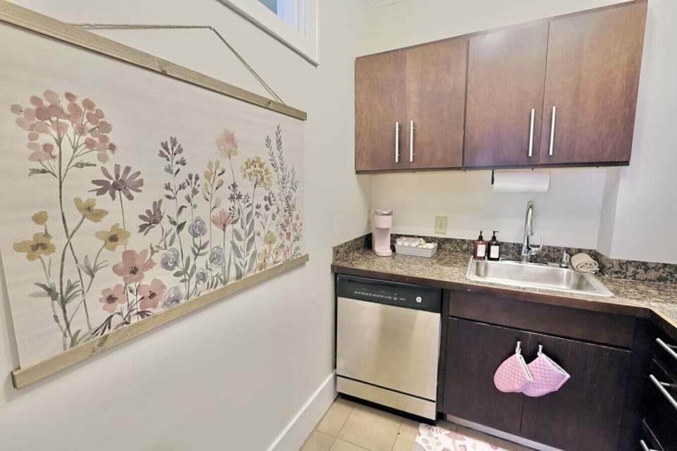 Kitchenette: Sleek countertops and floral decor create a delightful space for culinary adventures!