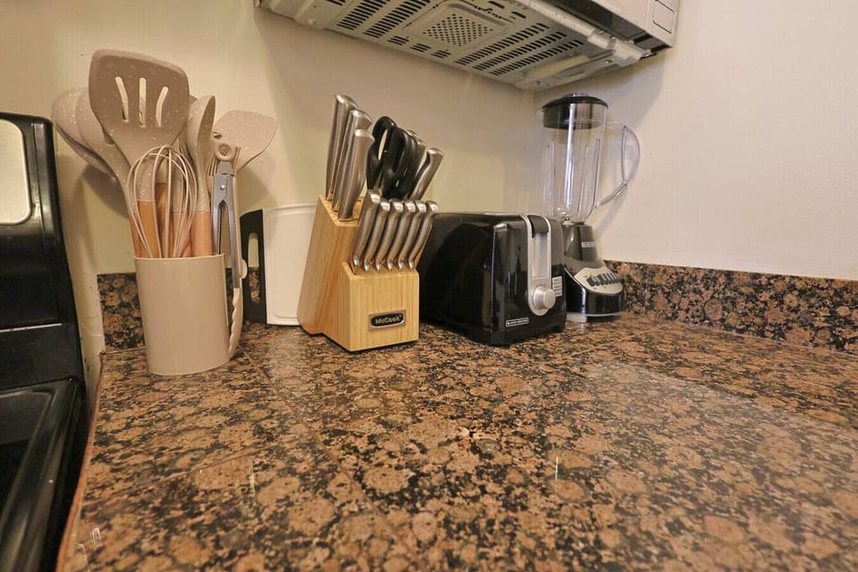 Kitchen: Whip up culinary delights with modern appliances and stylish utensils at your fingertips!
