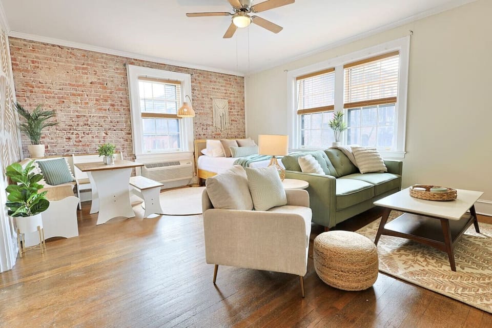 Living Room Retreat: Bright space with stunning brick walls, perfect for relaxation and fun!