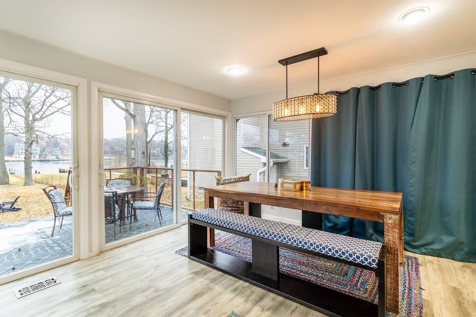 The glass sliders in the living/dining room offer access out to the back deck.