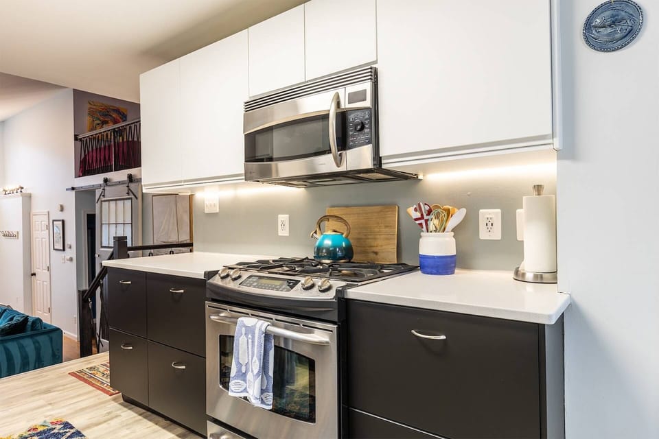The kitchen is centrally located in the middle of the home and is equipped with stainless steel appliances.