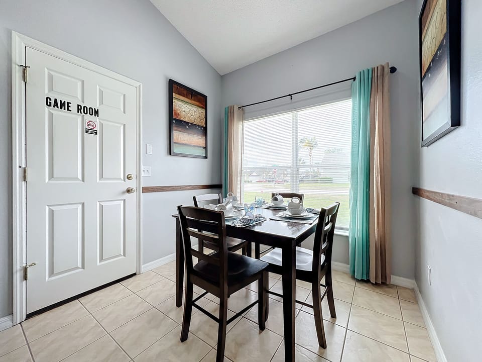 - Start your mornings with sunshine and coffee in this charming breakfast corner
- Large windows offer lovely views and fill the space with cheerful natural light
- Just open the door to unlock hours of fun in the private game room nearby