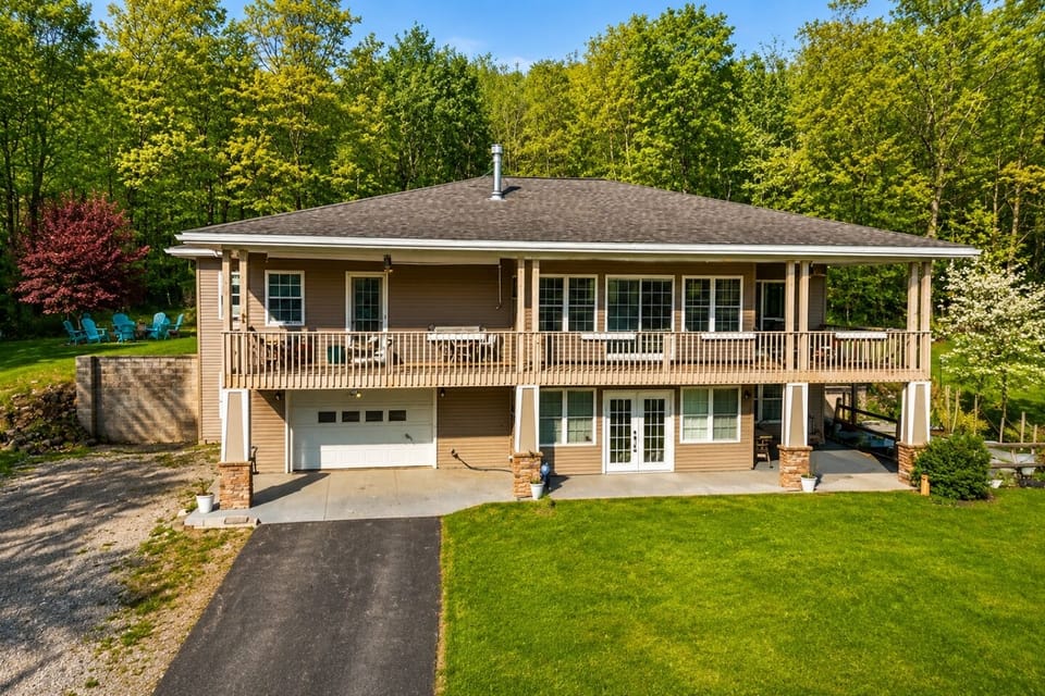 This elegant home, perched in a lush setting, offers a generous deck and spacious interiors, ideal for families or those seeking a peaceful, nature-bound lifestyle. 