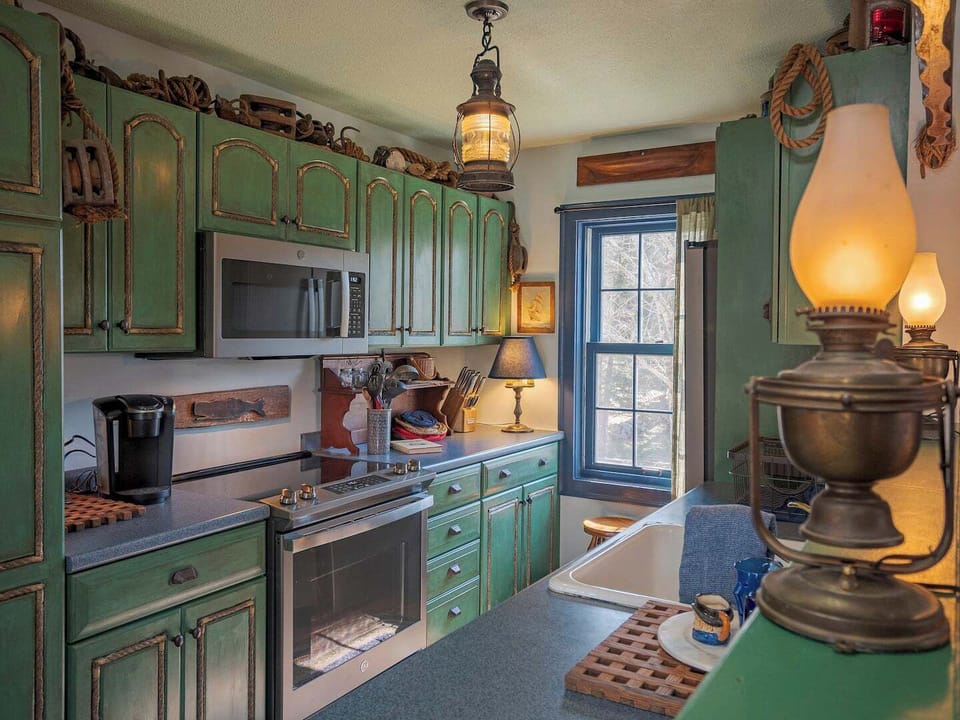 We've taken care of every little detail to help make your stay most enjoyable. Behind the nautical rope kitchen cabinets are all the supplies you'll need to fix a fabulous meal. 