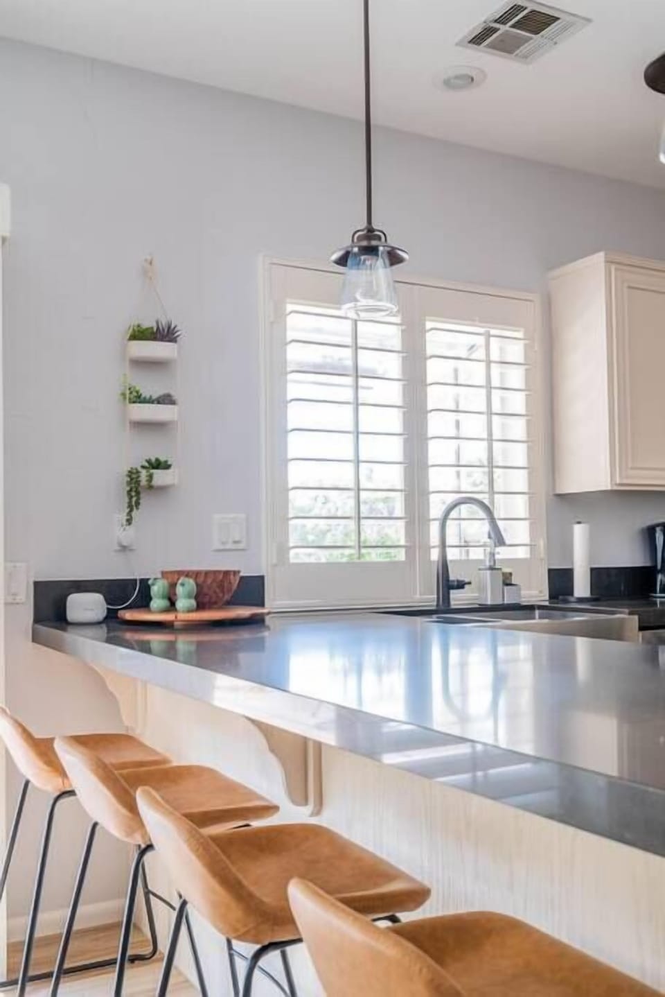 Large countertops and hanging bar lights. 