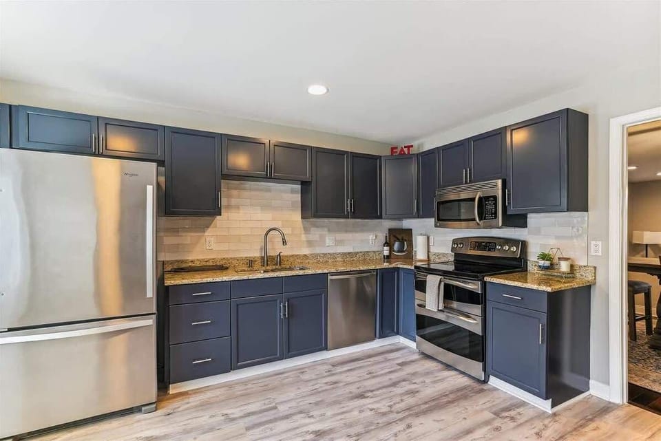 The newly renovated kitchen gleams w/ modernity and charm. Bathed in natural light cascading through expansive windows, it features sleek countertops, new appliances, and ample storage. Its airy ambiance and minimalist design create a culinary haven